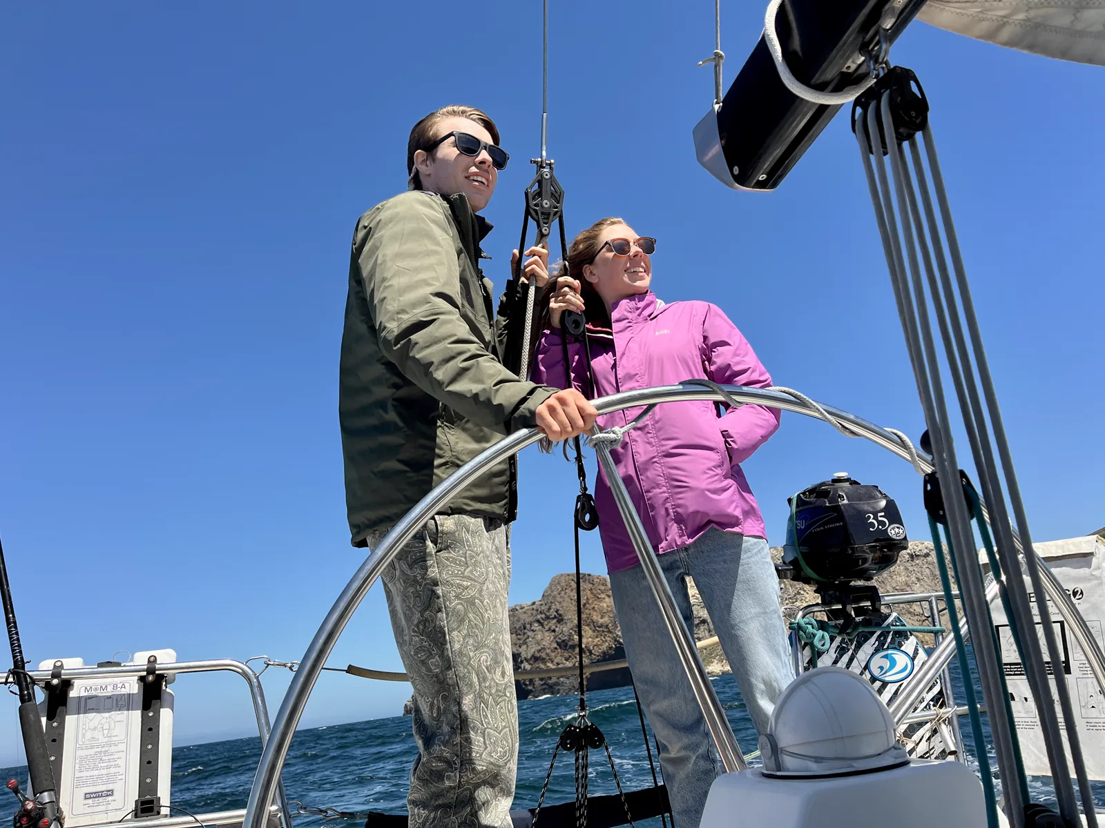 Tate and Hayley together at the wheel of a sailboat